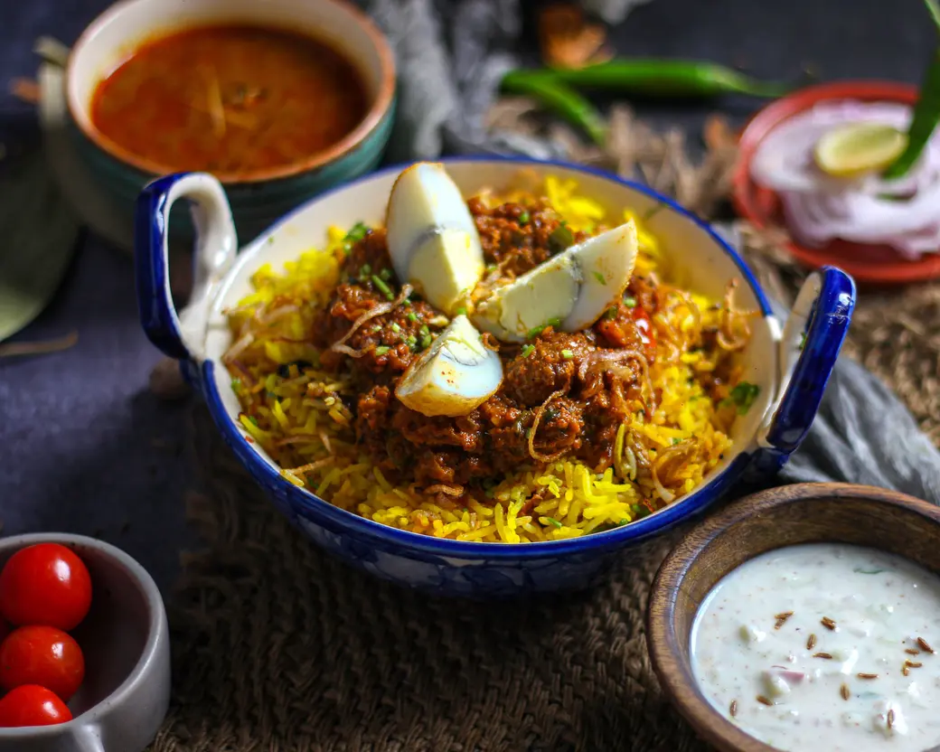 Weekend Biryani — Slow-cooked lamb shoulder, saffron rice, burnt onion, raita on the side. One pot, and when it is gone it is gone.